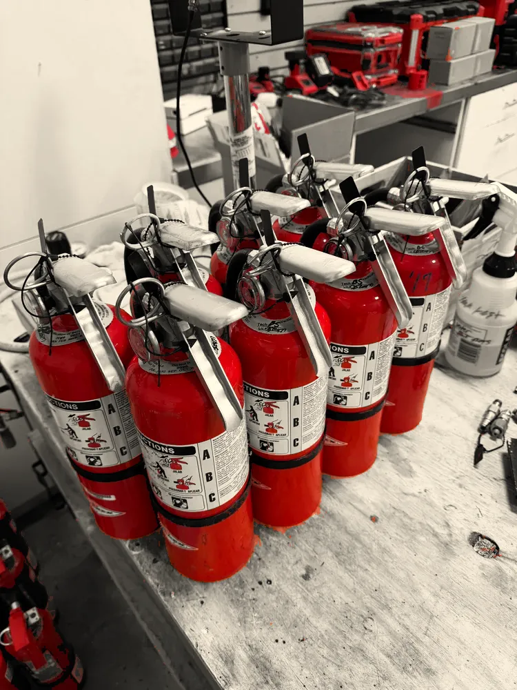 ABC dry chemical extinguishers on the Hamilton Fire Protection bench during service